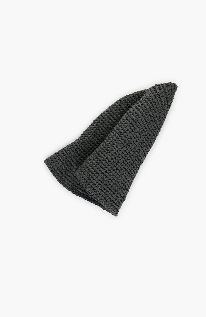 a crochet paper sun hat in charcoal colour from Karakoram Accessories rolled on a white background