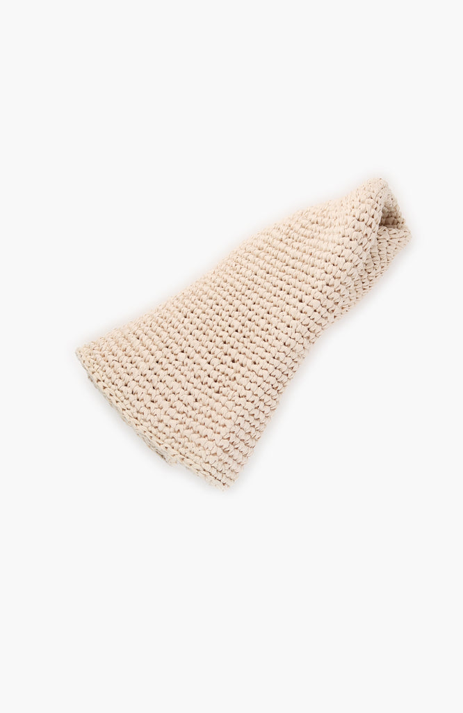  a crochet paper sun hat in ivory colour from Karakoram Accessories rolled on white background