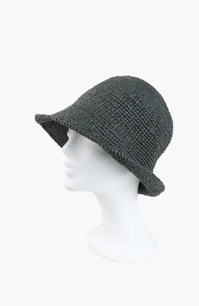  a crochet paper sun hat in thyme colour from Karakoram Accessories shown on a white mannequin's head viewed from the side