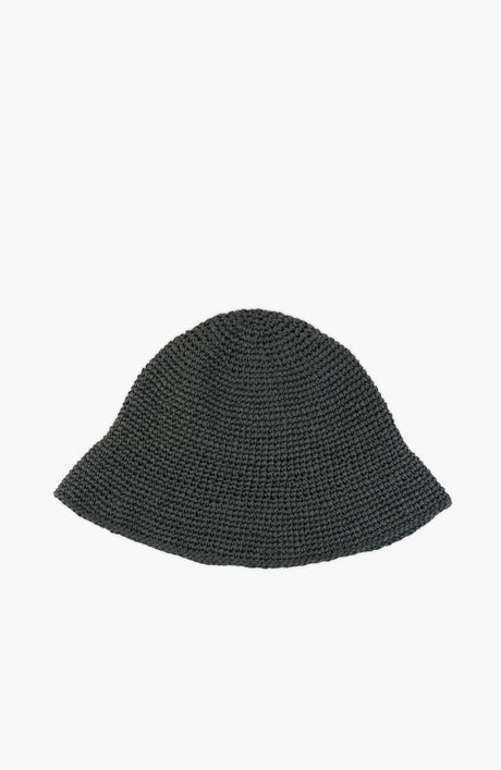 a crochet paper sun hat in thyme colour from Karakoram Accessories lying flat on white background