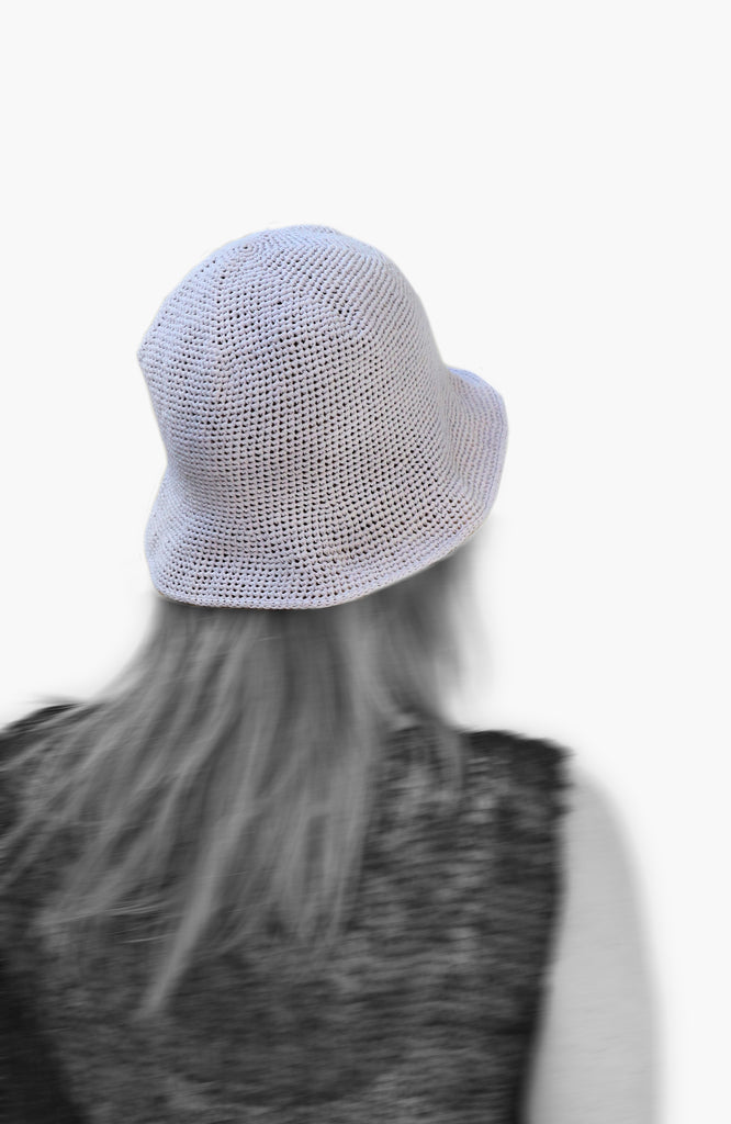 model wearing crochet bell hat in lavender colour from Karakoram Accessories